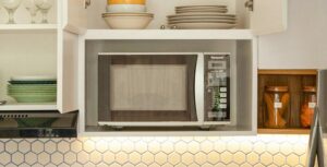 well-organized kitchen setup with a best microwave oven in an open cabinet. 